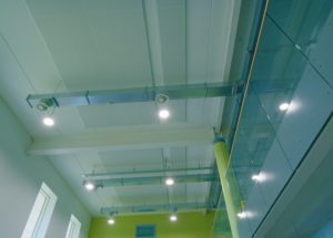 A well lit atrium using LED high bays in a large, modern Manchester high school.