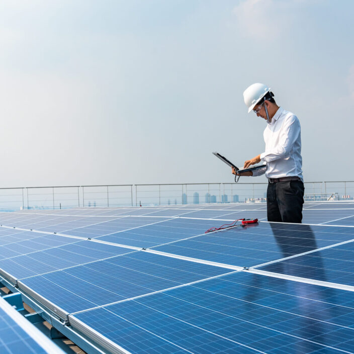 Engineer Monitoring Solar Panels on Roof