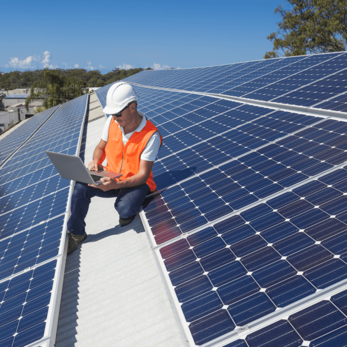 Engineer on Roof Moniroting Solar Panels